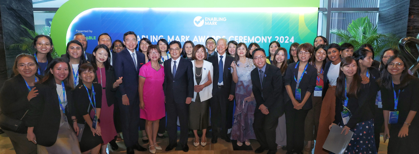 Group of people at "Enabling Mark Awards Ceremony 2024" with event backdrop.